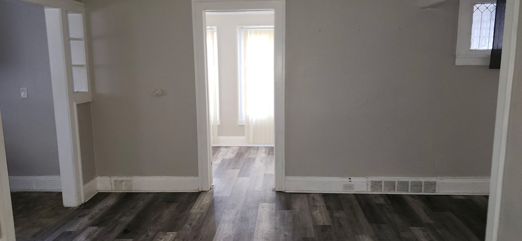 A room with wooden floors and white walls.