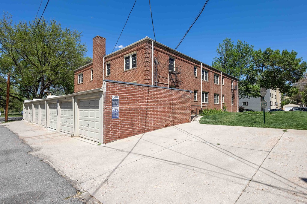 A red brick building with a white garage door.