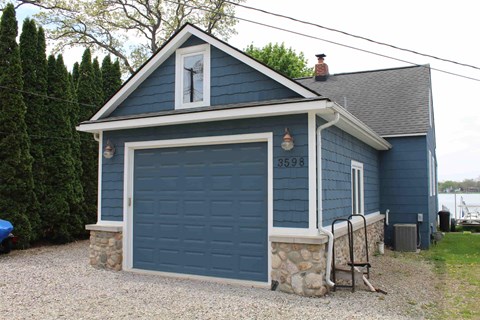 A blue house with a garage door that says 3599 on it.