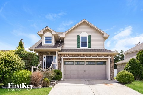 A house with a garage and a driveway is for sale.