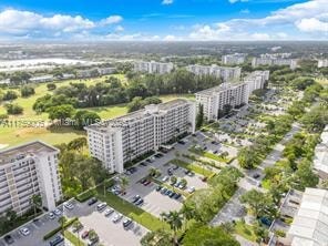 A bird's eye view of a residential area with multiple apartment buildings and a parking lot.
