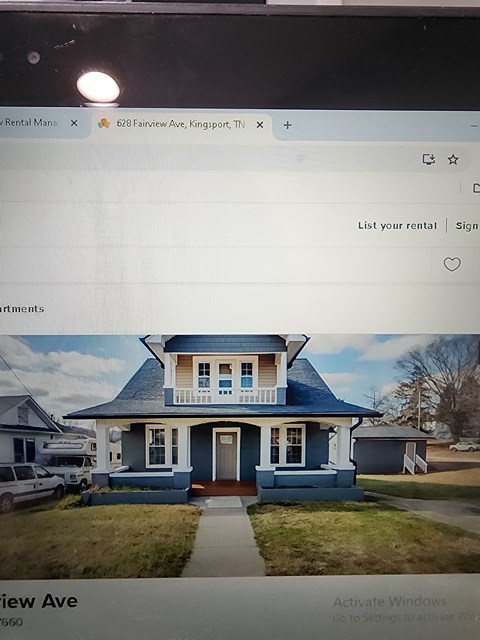 A computer screen displays a webpage for a rental property at 628 Fairview Ave, Kingsport.