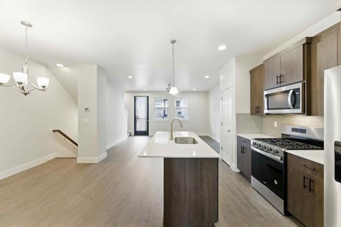 A modern kitchen with a stainless steel oven and microwave.