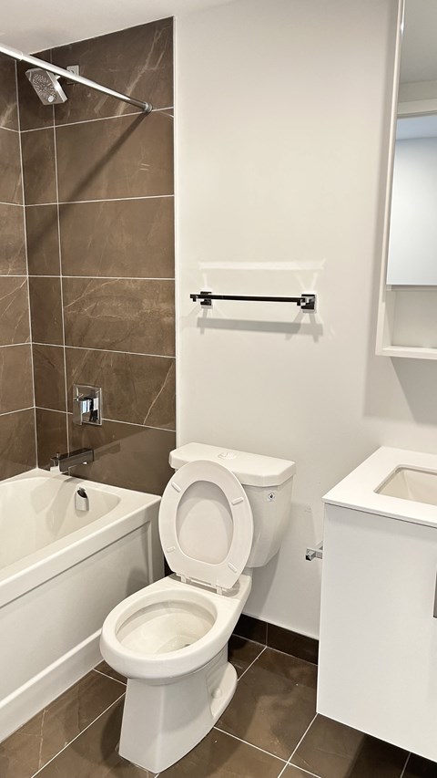 A white toilet in a tiled bathroom.