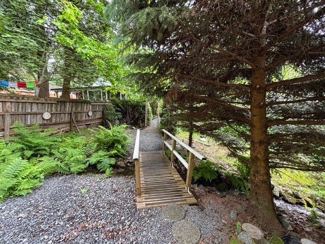 A wooden staircase leads up a tree in a forest.