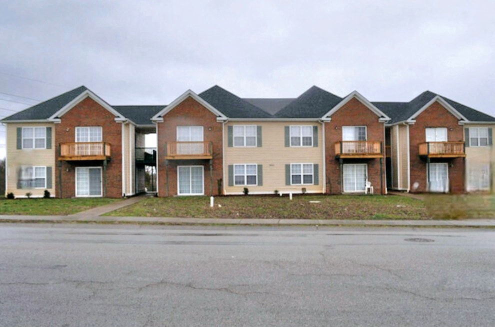 A row of brick apartment buildings with balconies.