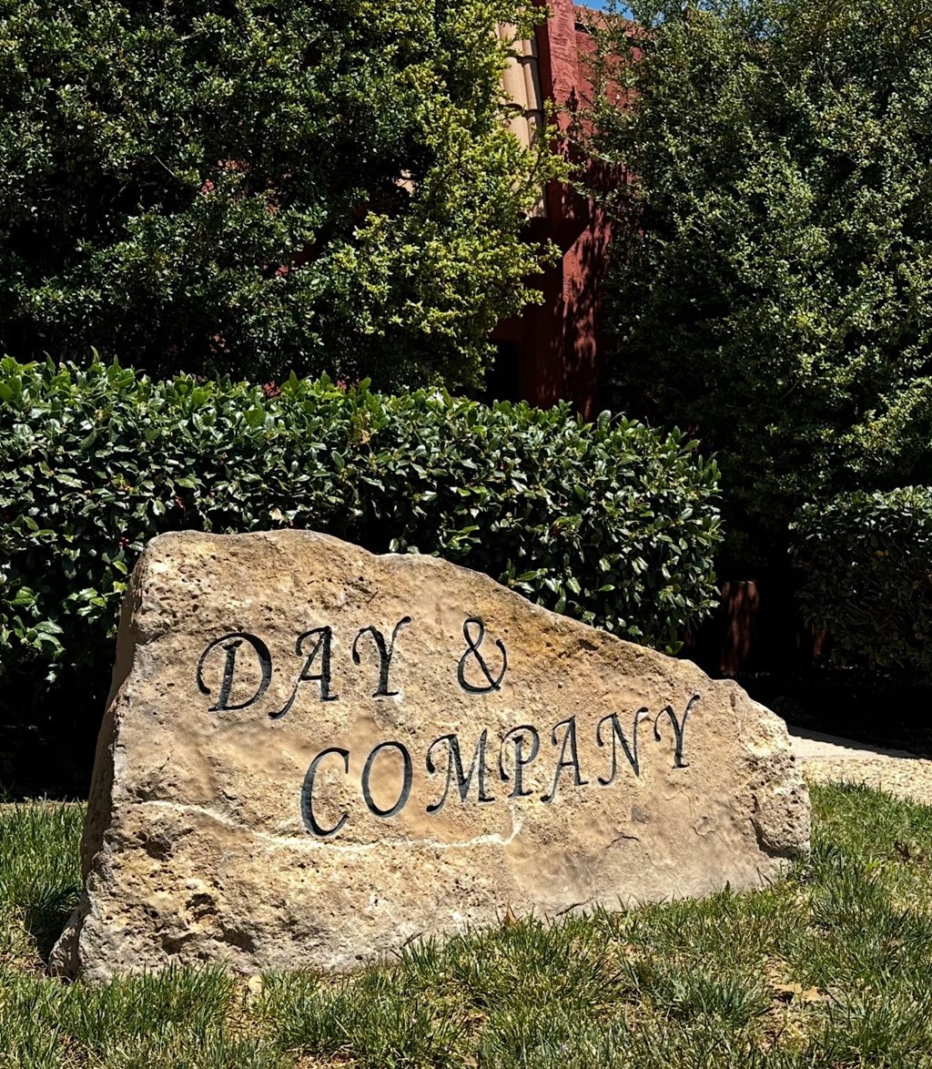 A stone with the words "Day & Company" carved into it.