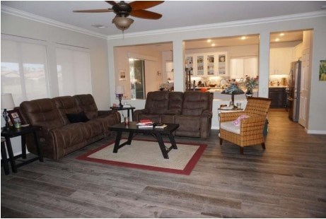 A living room with a brown couch and a ceiling fan.