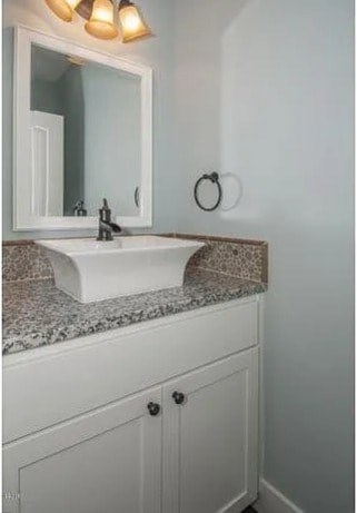 A white sink with a mirror above it.
