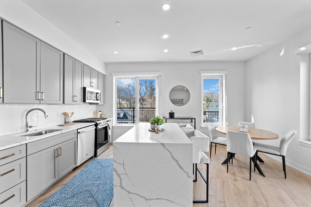 A modern kitchen with a dining table and chairs.