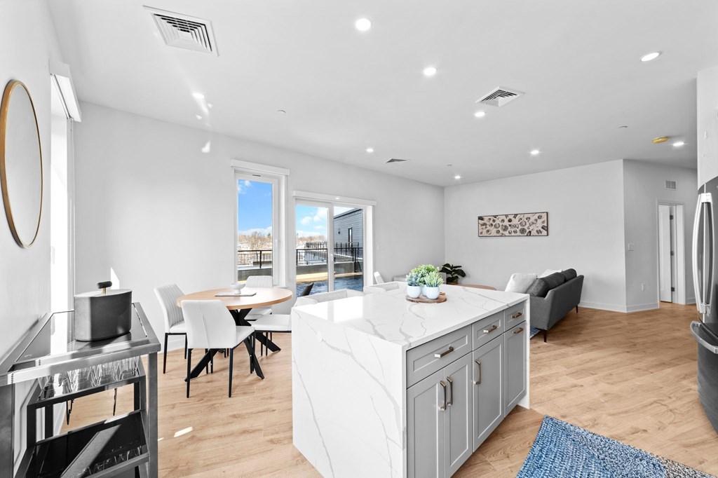 A modern kitchen with white cabinets and a large island.
