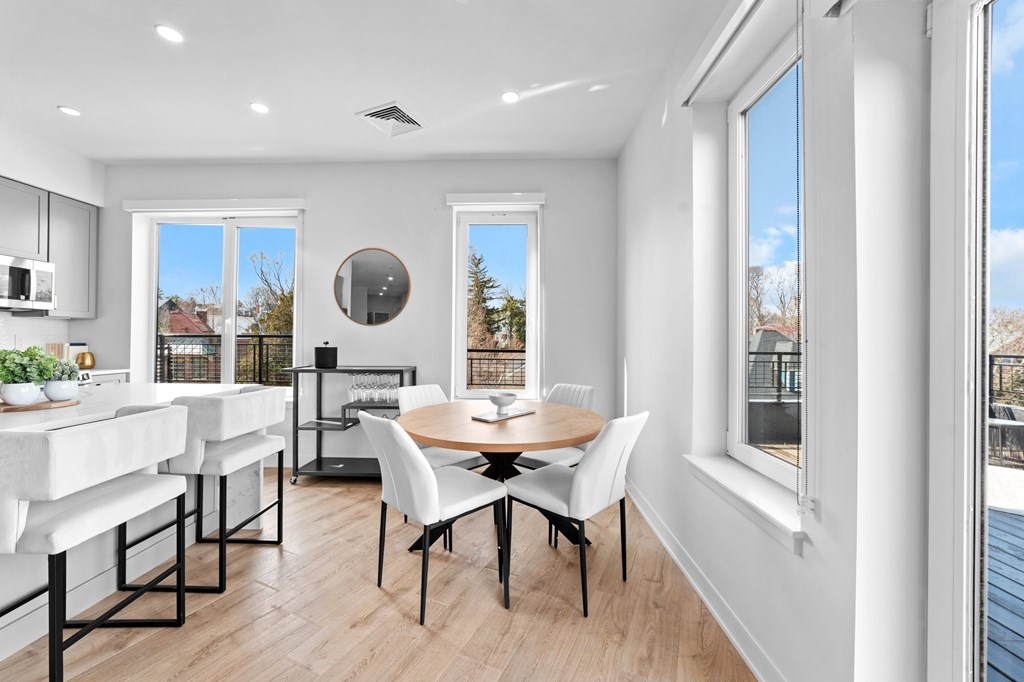 A modern kitchen with a dining table and chairs.