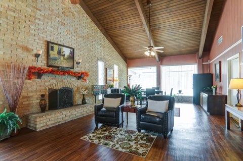 A living room with a fireplace and a painting on the wall.
