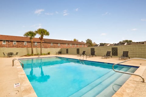 A swimming pool with a metal ladder and a metal railing.