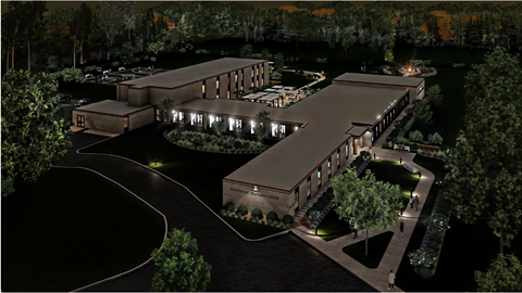 A nighttime rendering of a modern building complex surrounded by trees.