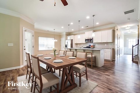 A dining room with a wooden table and chairs.