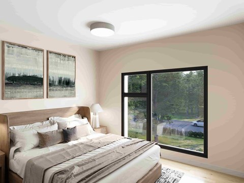 A bedroom with a large bed and a view of a car and trees outside.