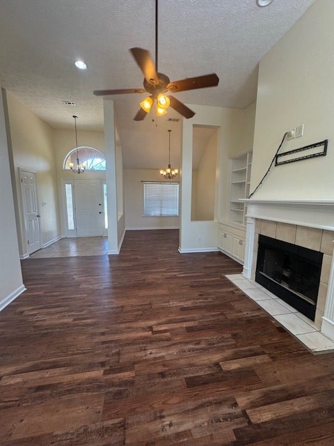 A living room with a fireplace and wood flooring.