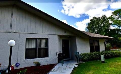A house with a red carpet and a white wall.