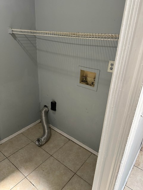 A room with a white baseboard and a white door frame.