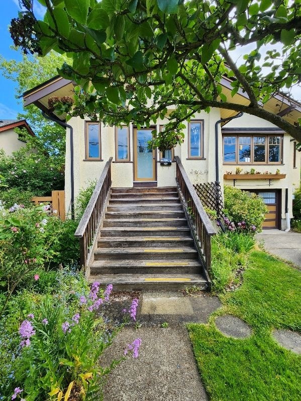 A house with a staircase leading to the front door.