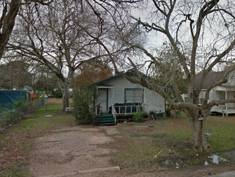 A small house with a tree in front of it.