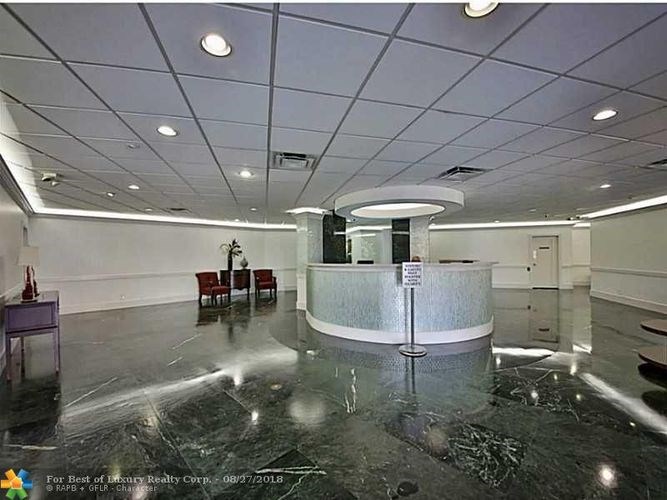 A polished marble floor in a well-lit room with a circular table in the center.