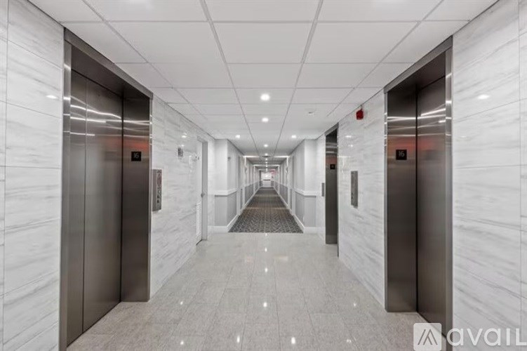 A long hallway with elevators on both sides.