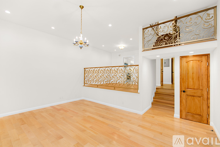 A room with wooden floors and a chandelier.