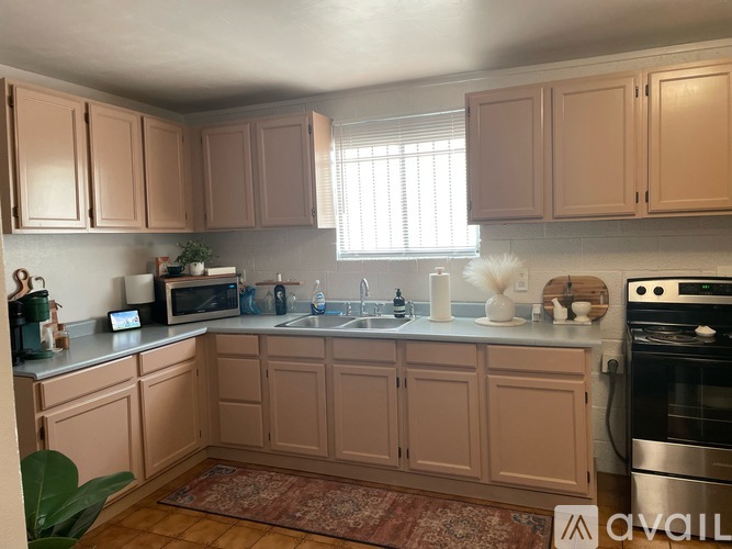 A kitchen with wooden cabinets and a stainless steel oven.