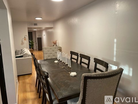 A dining room with a long table and chairs.