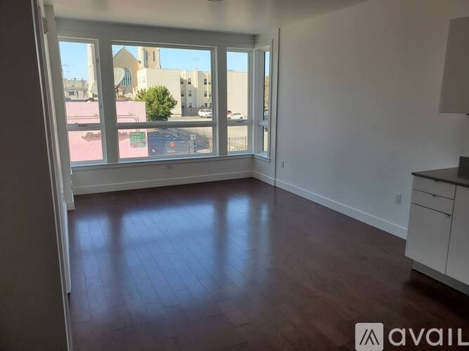 A room with a large window overlooking a street.