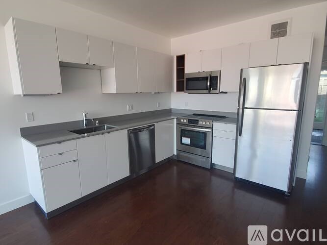 A kitchen with white cabinets and stainless steel appliances.