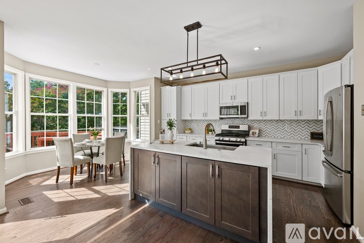 A kitchen with wooden cabinets and a white countertop.