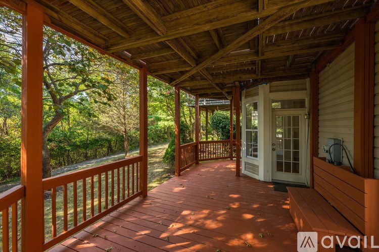 A living room with a couch, coffee table, and potted plant.