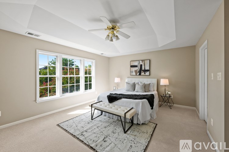 A kitchen with a white countertop and black cabinets.