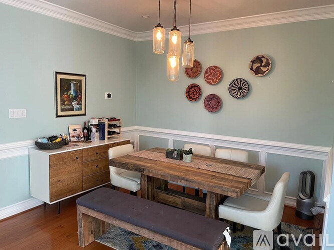 A dining area with a wooden table and chairs.
