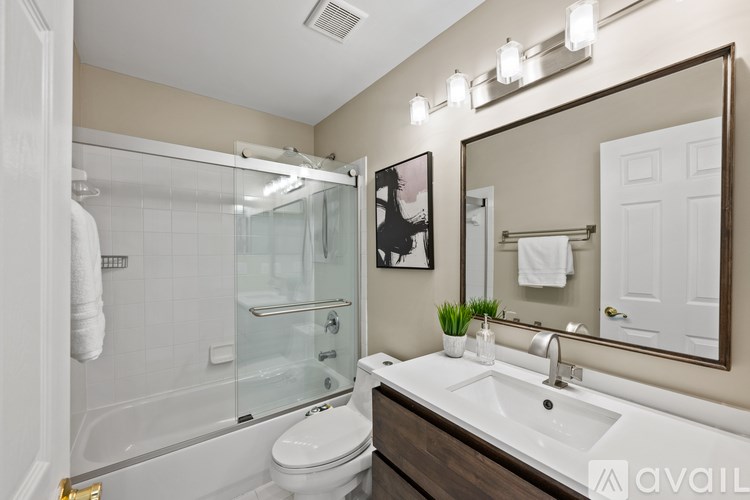 A red wooden deck with a basketball hoop and a tree.