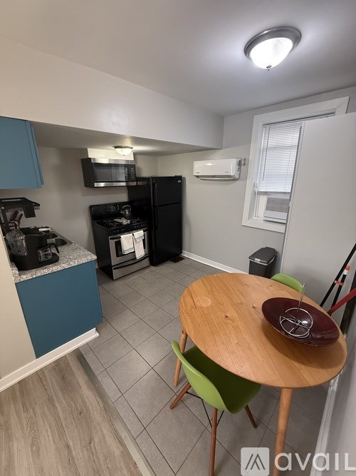 A kitchen with a black stove and a black refrigerator.