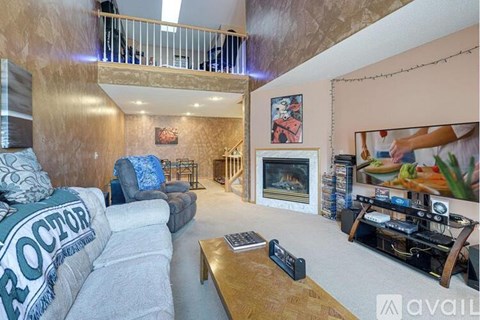 A living room with a grey sofa and a wooden coffee table.