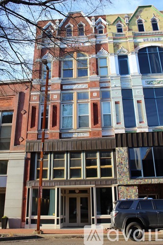 A multi-story building with a mix of red, yellow, and blue colors.