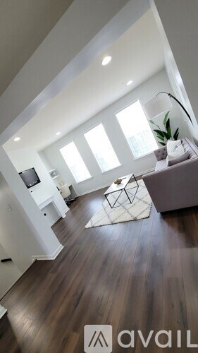 A living room with a white couch and a television.