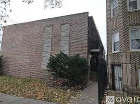 A brick building with a white door and windows.