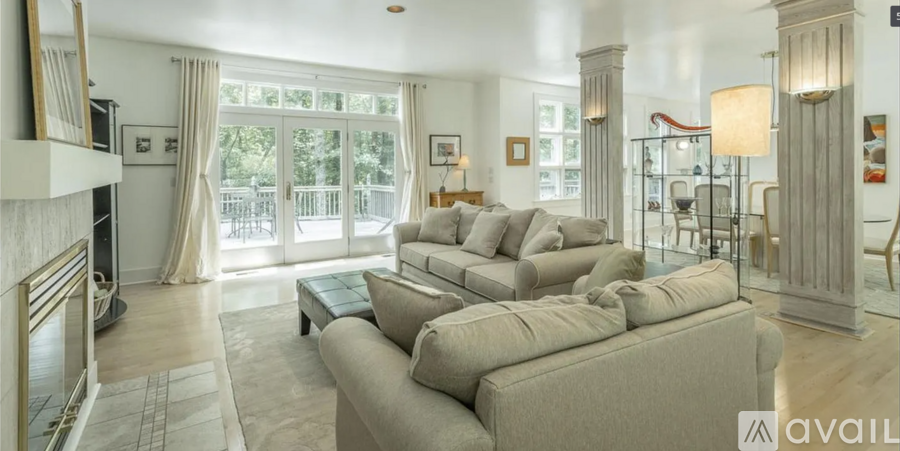 A living room with a large couch and a fireplace.