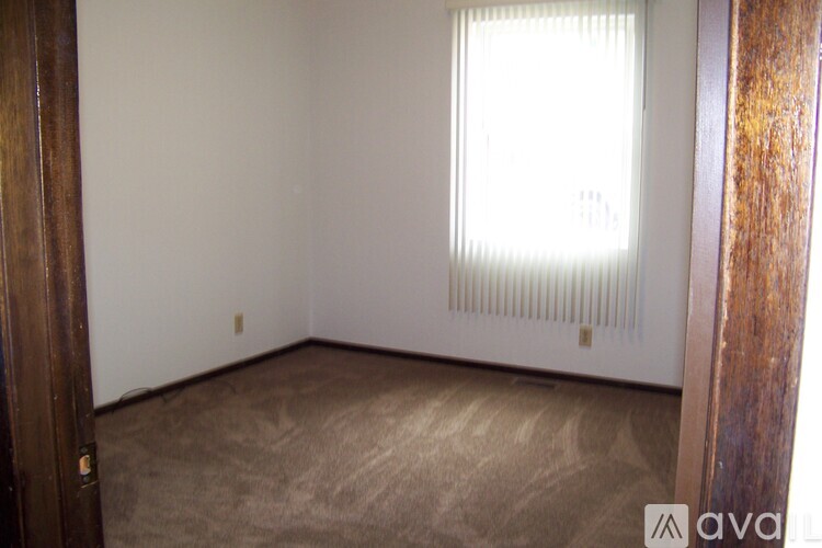 A room with a window and a radiator on the wall.