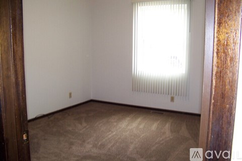 A room with a window and a radiator on the wall.