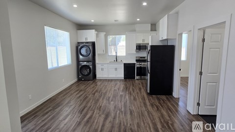 A kitchen with black appliances and white cabinets is shown.