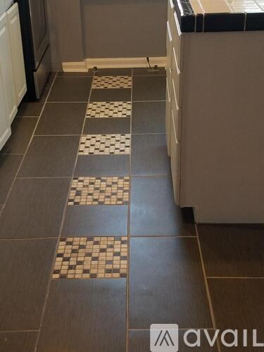 A kitchen with a checkered tile floor.