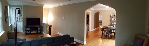 A living room with a couch and a television.