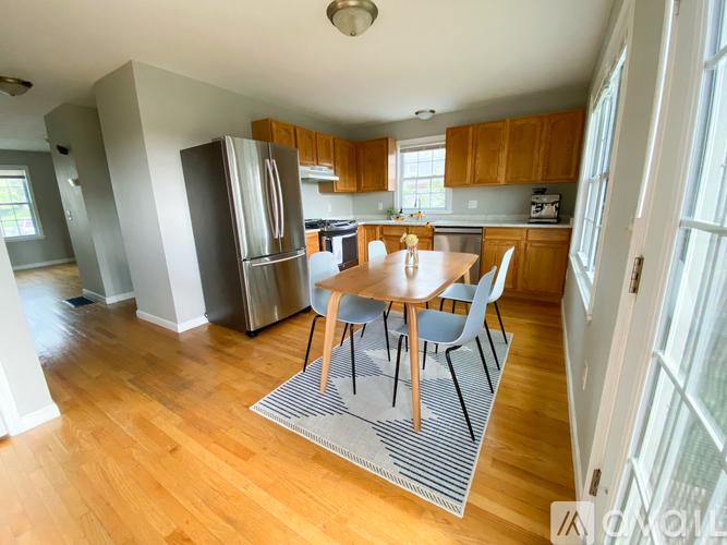 A kitchen with a table and chairs in the middle of the room.